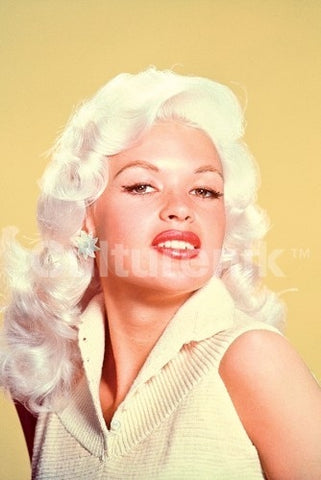 color photo portrait image of Jayne Mansfield wearing white against a pale yellow background