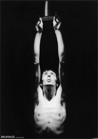 Bauhaus' Peter Murphy lit on dark stage with arms up, looking up 24" x 36" photographic image poster