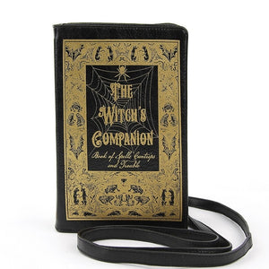 textured black faux leather with metallic gold print book-shaped "The Witch's Companion" clutch purse with detachable wristlet and crossbody straps