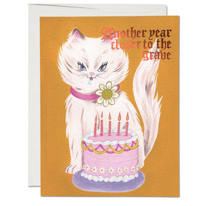 4.25" x 5.5" card "Another year closer to the grave" pink foil text fancy white cat and pink birthday cake gold background illustrated image
