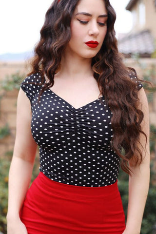 fitted black & white polka dot print top in stretch knit cap sleeves sweetheart neckline, shown on model wearing red skirt