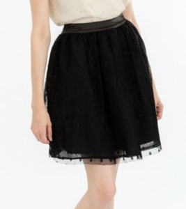 gathered black above-the-knee length skirt with layers of flocked polka dot black tulle shown on model