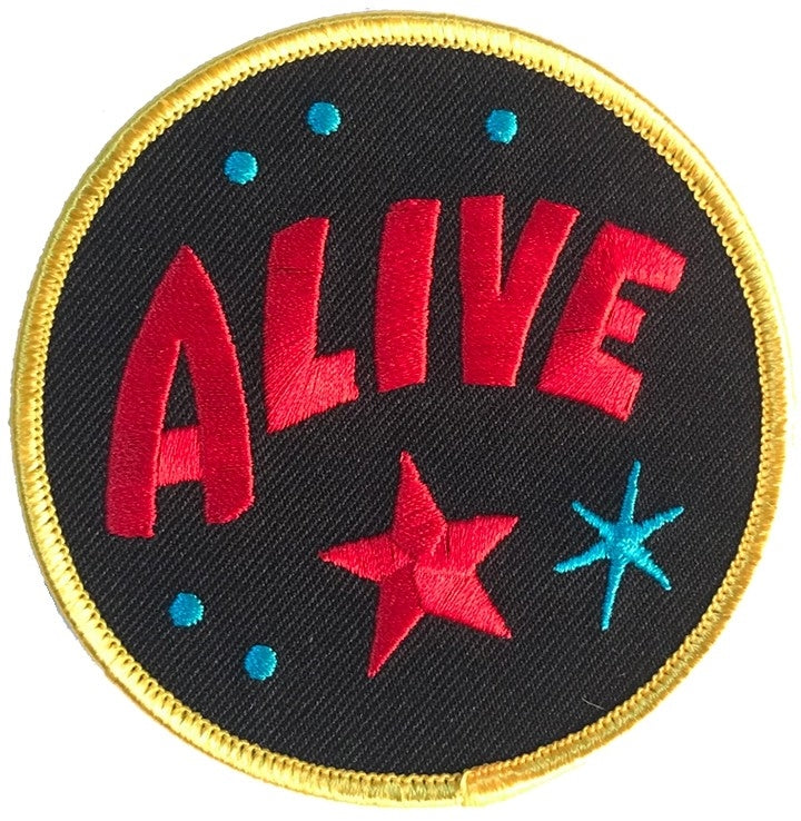 Sideshow banner style "ALIVE" 3 1/2" round black red blue yellow embroidered patch
