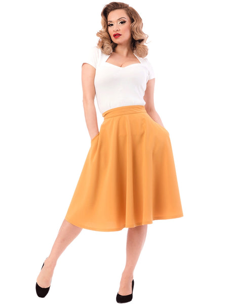 mustard yellow knee-length swing skirt with pockets, shown on model