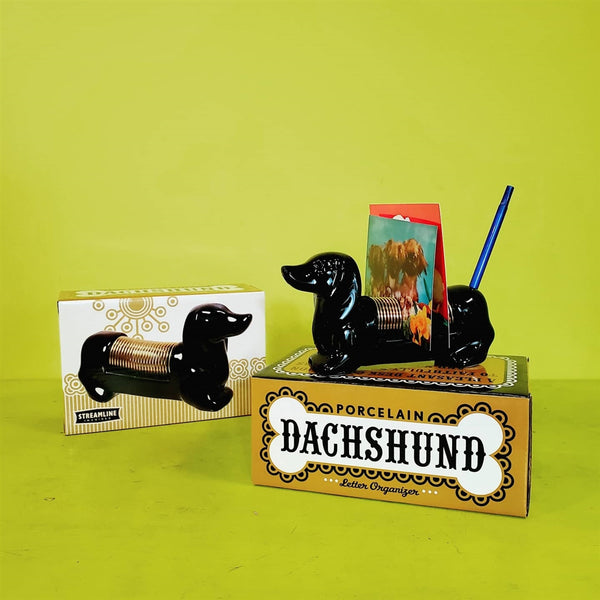 6" black ceramic brass tone metal coil Dachshund shaped letter organizer desktop decor, shown holding pen and postcards, alongside photo image giftbox packaging