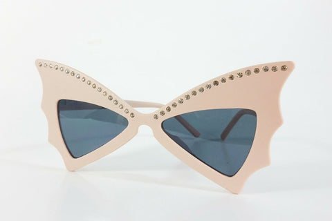matte dusty pink plastic frame rhinestone embellished batwing shaped sunglasses with dark smoke lens
