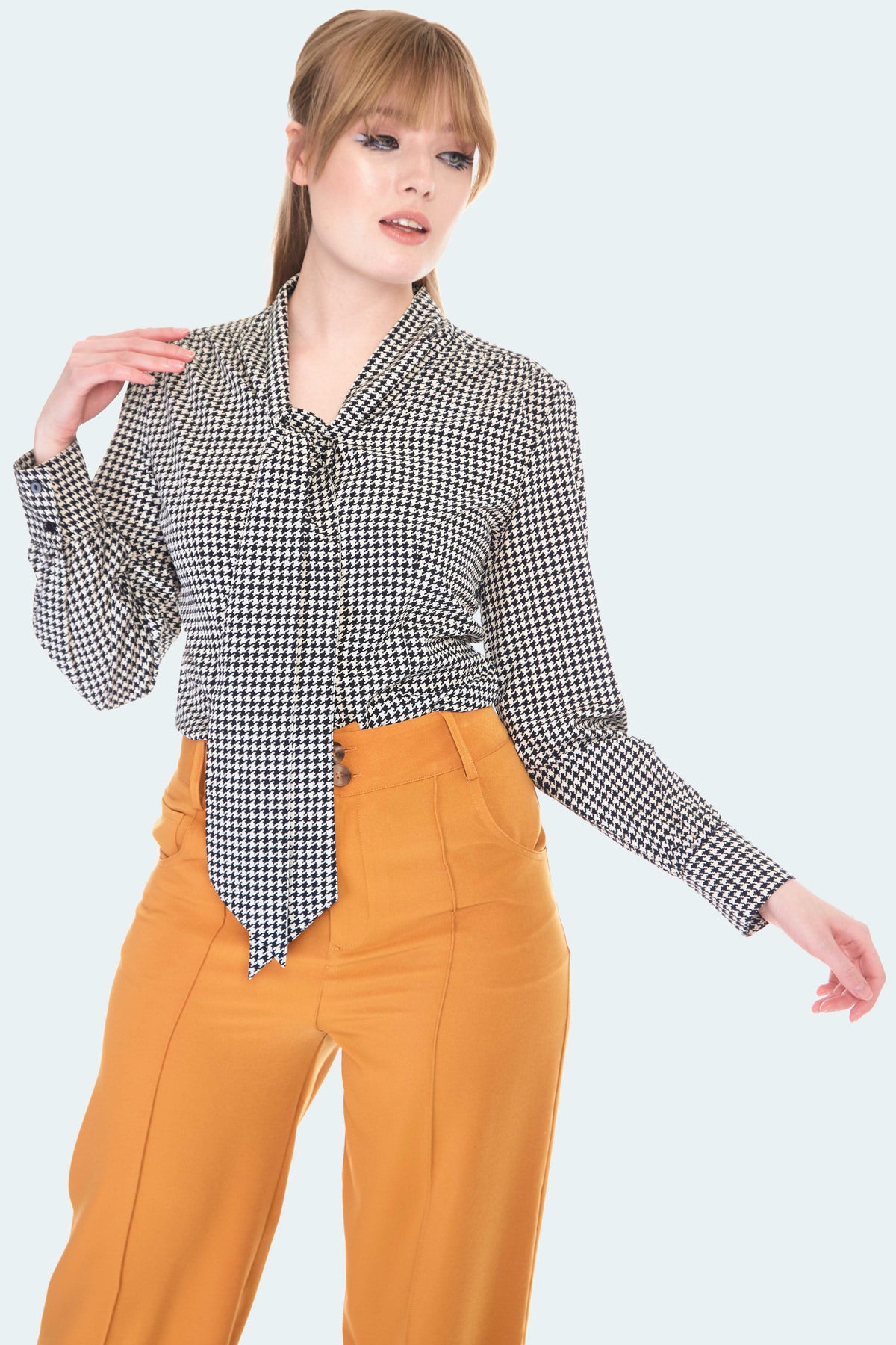 A 3/4 length shot to show the blouse tucked into a pair of high waisted pants 