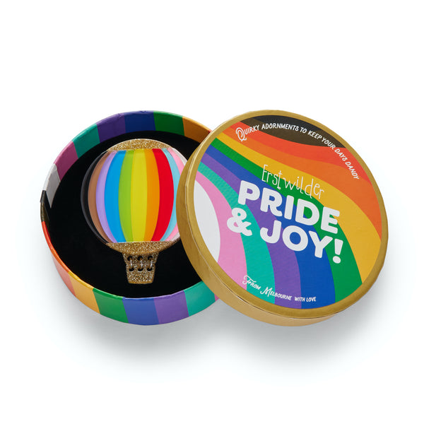 Pride & Joy Collection "Inclusion Around the World" inclusion rainbow striped hot-air balloon layered resin brooch, shown in illustrated round box packaging