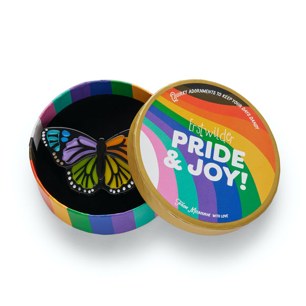 Pride & Joy Collection "Prince of Pride" rainbow colored butterfly layered resin brooch, shown in illustrated round box packaging